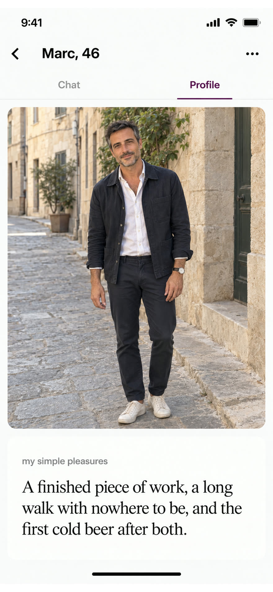 Marc standing relaxed in a well-fitting jacket on a stone street, hands visible, beside his answer about finished work, a long walk and a cold beer.